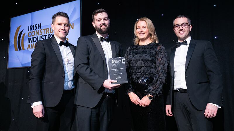 Stephen Grant, BIM manager, Petruf Consulting, presents the Project Management Firm of the Year award to the Mitchell McDermott team.