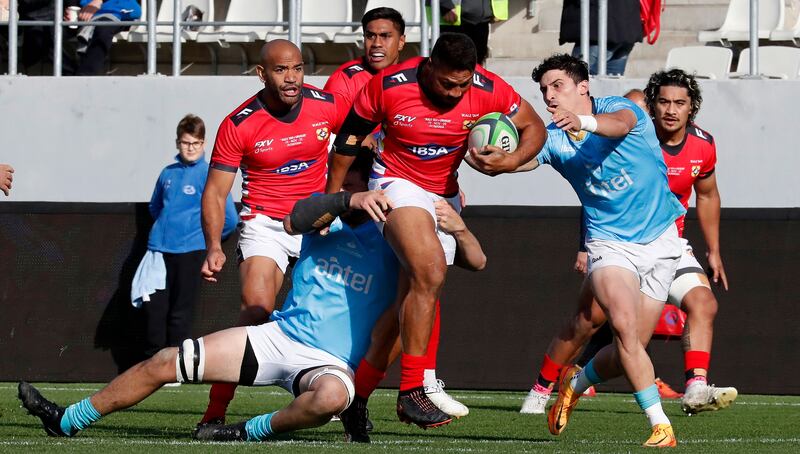 Tonga's William Havili in action against Uruguayan players Ignatio Dotti (left) and Baltazar Amaya during the World Rugby match between Tonga and Uruguay in Bucharest, Romania, November 19th, 2022.