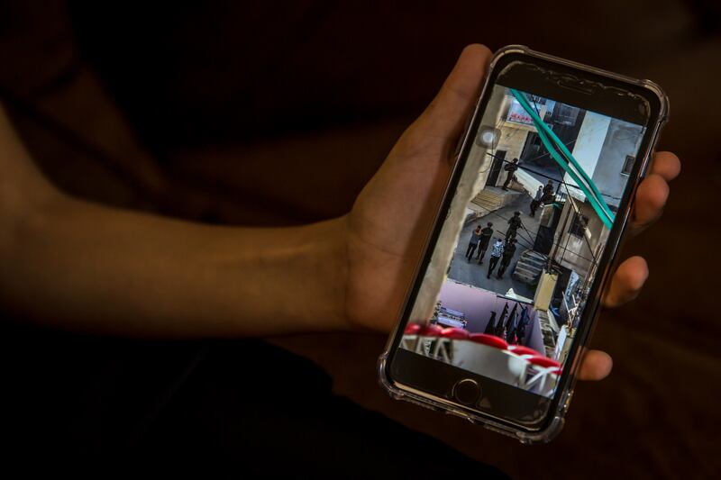 A boy shows images of an Israeli raid on Jenin refugee camp which he captured on his phone. Photograph: Sally Hayden