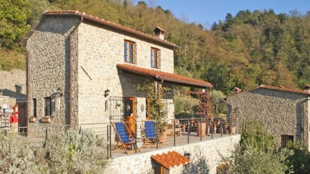 Tuscan home with garden set in chestnut and olive groves overlooking a valley, 100sq m house is traditional in style with exposed stone walls
