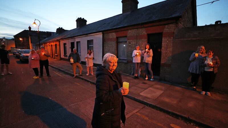 An image from during ‘Shine Your Light’ The Beresford Group, front and centre was Margaret Cunningham with neighbours (from left) Elizabeth and Kevin Dalton, Terry and Anne Crosbie, Carol and Ciara Byrne and Tara with Lily Kilkenny. Photograph: Nick Bradshaw / The Irish Times
