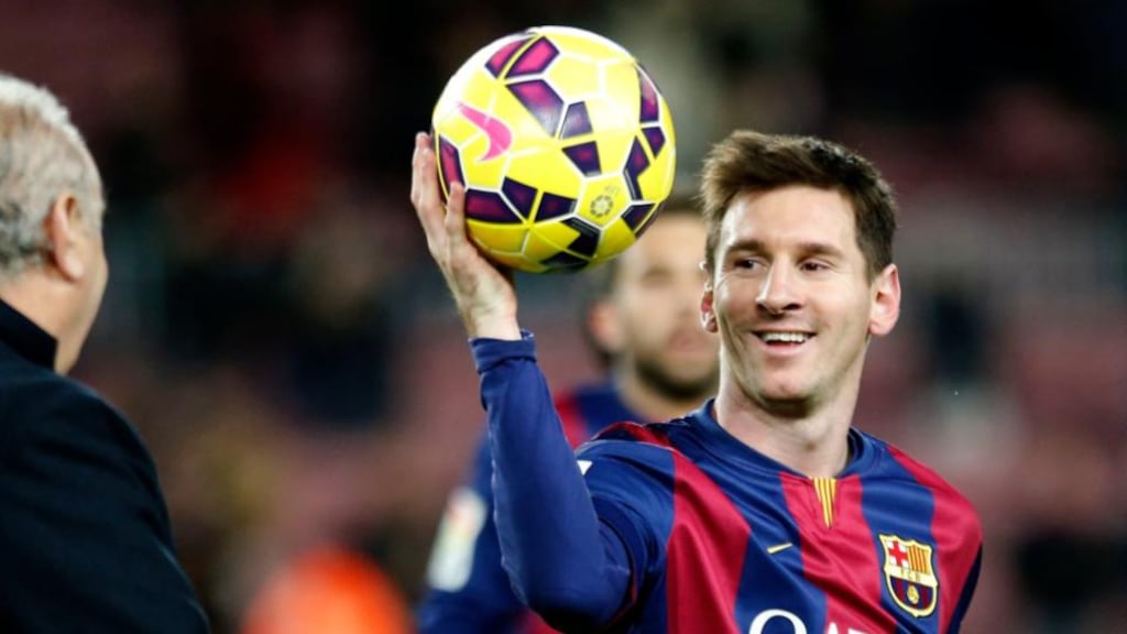 Barcelona’s Lionel Messi collects the ball after scoring his hat trick against Espanyol during their Spanish first division soccer match at Nou Camp stadium in Barcelona. Photograph: Gustau Nacarino/Reuters