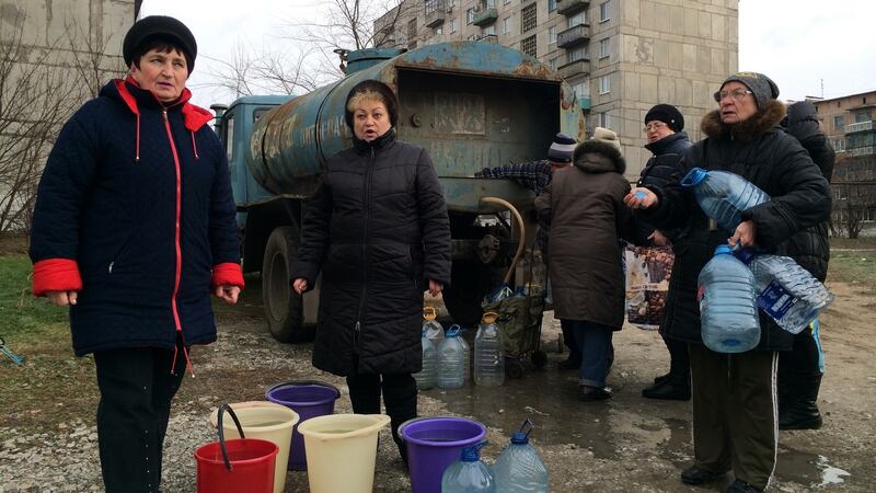 Valya Burakova (in spectacles, on right) and her neighbours collect water from a tanker in Toretsk, eastern Ukraine, where the water supply was cut by shelling on November 22nd. Photograph: Daniel McLaughlin