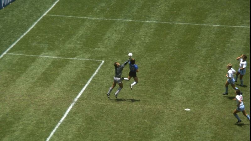 Diego Maradona nudges the ball past Peter Shilton of England to score the famous Hand of God goal. Photograph: Getty Images
