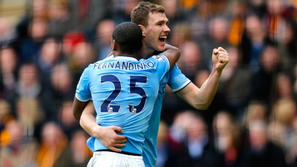 Edin Dzeko of Manchester City celerates with teammate Fernandinho after scoring his team’s second against Hull City at KC Stadium. Photograph: Paul Thomas/Getty Images