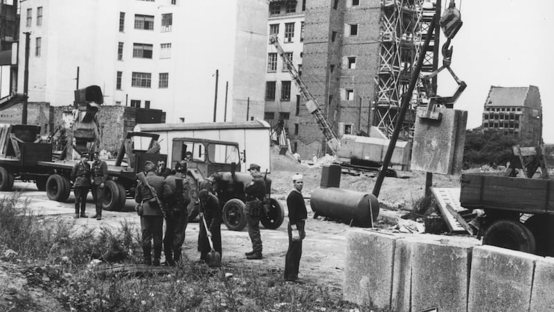 August 1961: East German military personnel supervising construction of the Berlin Wall. Photograph: Central Press/Getty Images