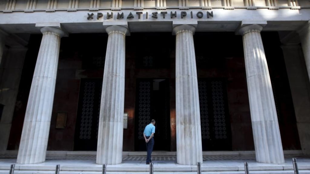 A man enters the old stock exchange building in central Athens. Greek stocks have suffered an almighty collapse, falling by 85 per cent since 2007. Photograph: Jean-Paul Pelissier/Reuters