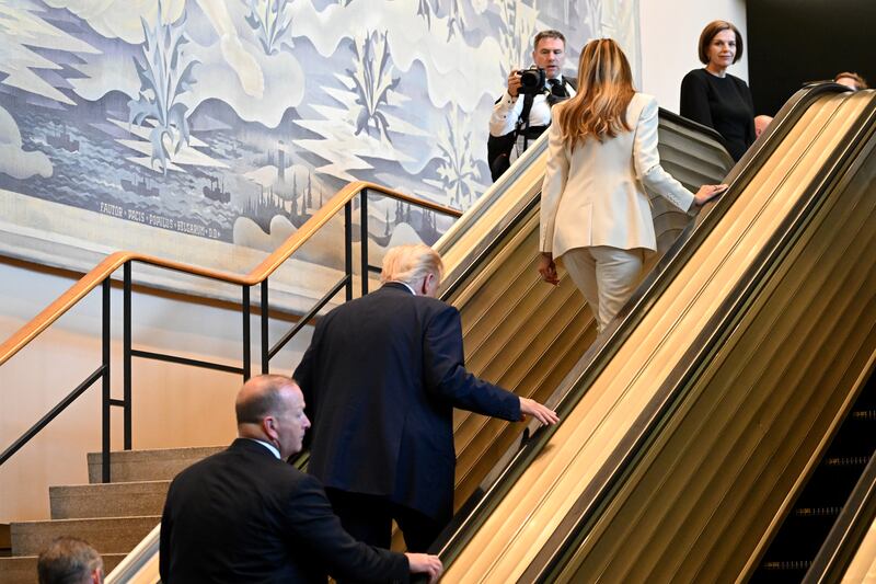Trump and first lady Melania walk up an escalator as they arrive at the UN General Assembly in New York. Photograph: Alexi J Rosenfeld/Getty Images