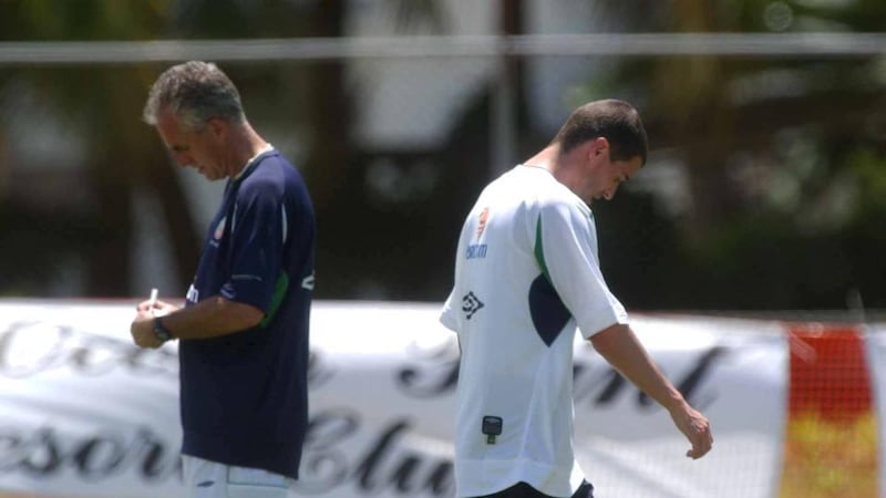 Republic of Ireland captain Roy Keane walks past manager Mick McCarthy during training in Saipan. Photograph: David Maher/Sportsfile