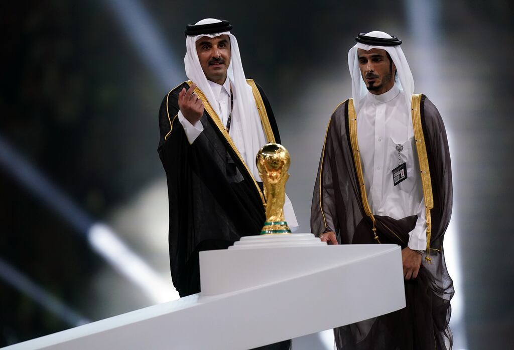Emir of Qatar, Sheikh Tamim bin Hamad Al Thani (left) with the World Cup trophy ahead of the presentation to Argentina's Lionel Messi following the World Cup final. Photograph: Mike Egerton/PA