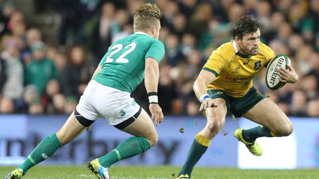 Australia’s Adam Ashley-Cooper tries to find a way around Ireland’s Ian Madigan at the Aviva Stadium. Photograph: Colm O’Neill / Inpho