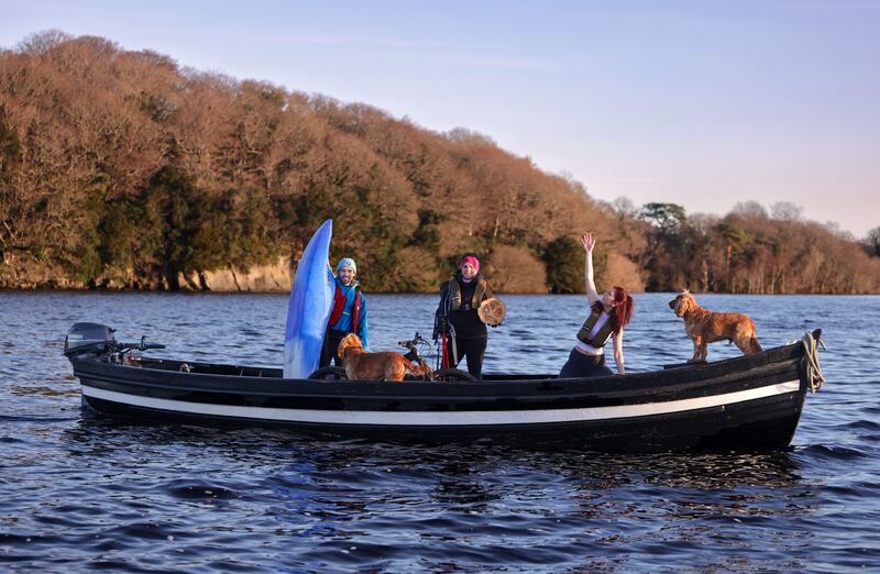 Nicole O'Brien, right, Claire Tangney and Donal O'Donoghue, and their faithful companions, Bob and Marley, on board a traditional Killarney Gap of Dunloe boat to herald the return of the Wander Wild Festival. Photograph: Valerie O'Sullivan