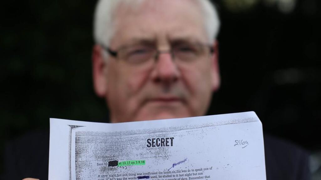 Michael Gallagher, who lost his son Aidan in the Omagh bomb attack, holds a redacted email from a Real IRA mole during a press conference on behalf of the Omagh Bomb Survivors group yesterday. Photograph: Niall Carson/PA