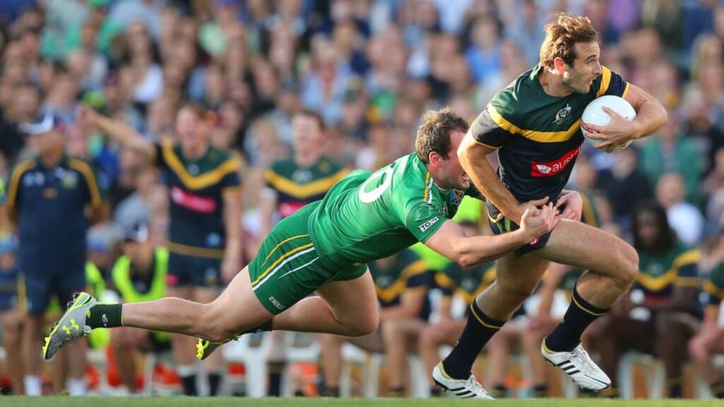 Australia’s Jobe Watson looks to break free form the clutches of Ireland captain Michael Murphy at Paterson Stadium in Perth. Photograph: Cathal Noonan / Inpho