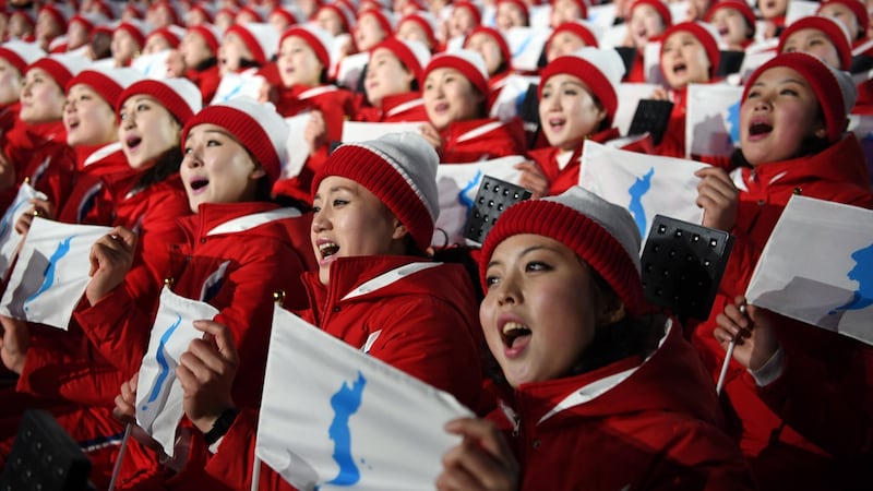 North Korean athletes sing and hold the unification flag depicting a unified Korean peninsula before the start of the opening ceremony of the Winter Olympics in Peongchang. Photograph: James Hill/The New York Times
