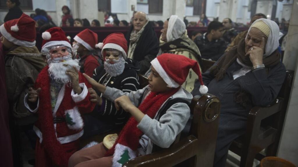 A file picture of Egyptian Coptic children attending a  new year Mass  at the Virgin Mary Coptic Christian church in  Al-Warrak, Cairo. The Egyptian capital this Christmas is a sanctuary for Syrian, Sudanese, Libyan, Somali, and Palestinian refugees. Photograph: Khaled Desouki/AFP/Getty Images