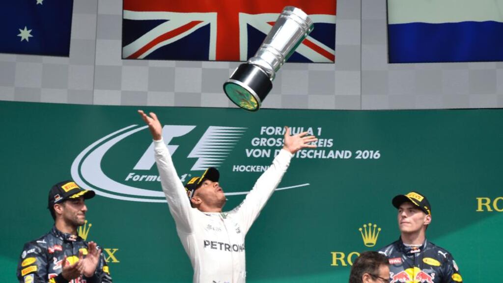 Mercedes driver Lewis Hamilton throws the trophy in the air after winning the German Grand Prix at the Hockenheim. Photograph: Thomas Kienzle/AFP/Getty Images