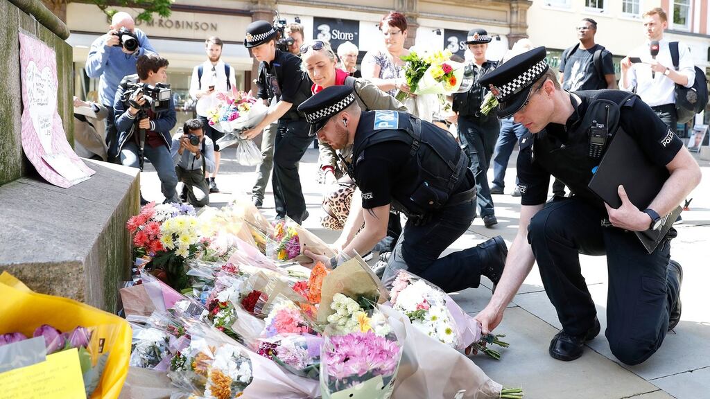Flowers are left in St Ann’s Square, Manchester, the day after an explosion tore through fans leaving a pop concert in Manchester. Photograph: Martin Rickett/PA