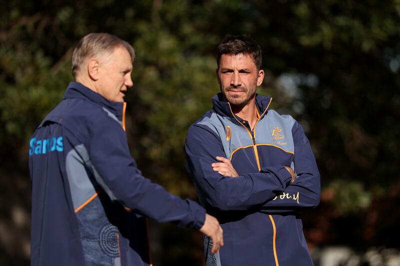Australia head coach Joe Schmidt talks with scrumhalf Jake Gordon a visit to Stanmore Public School in Sydney on Thursday. Photograph: Matt King/Getty Images for ARU