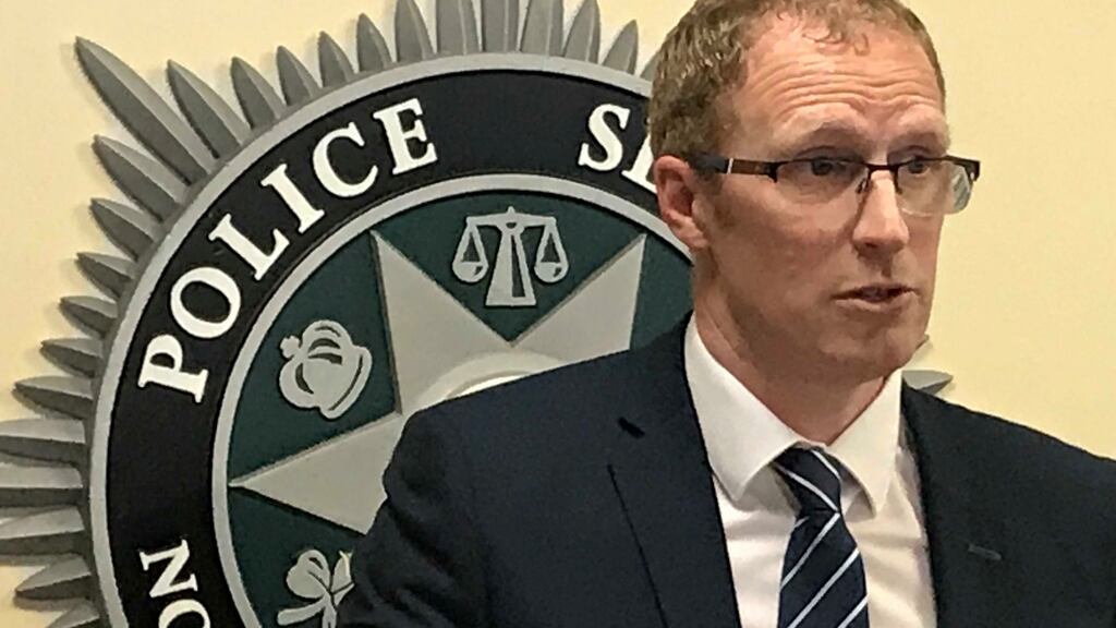 Detective Inspector Mark Bell briefs the media on the human trafficking investigation at PSNI headquarters in Belfast. Photograph: Rebecca Black/PA Wire