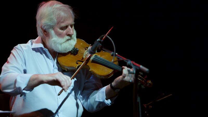 John Sheahan playing on stage.