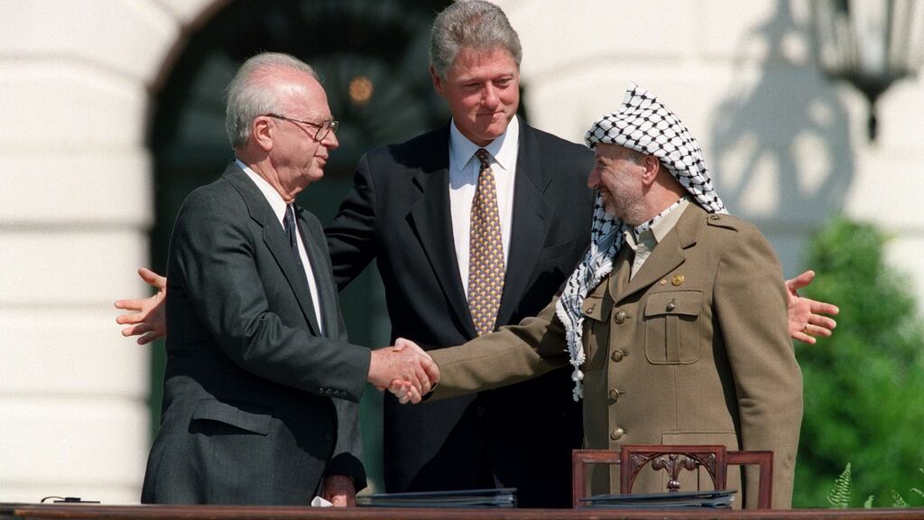 On September 13th, 1993, US president Bill Clinton stands between PLO leader Yasser Arafat and Israeli prime minister Yitzahk Rabin as they shake hands. Photograph: J David Ake/AFP/Getty Images