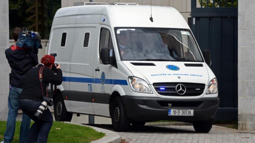 John Dundon is driven under escort, from the Special Criminal Court, after being sentenced to life in prison for the murder of rugby player Shane Geoghegan, yesterday. Photograph: Eric Luke