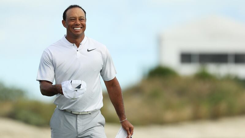 Woods smiles as he leaves the 18th green. Photo: Mike Ehrmann/Getty Images