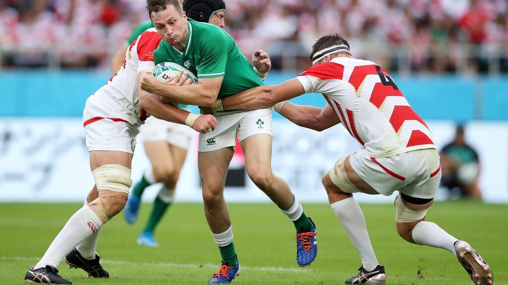 Japan’s Pieter Labuschagne and Luke Thompson tackle Jack Carty. Photograph: Cameron Spencer/Getty)