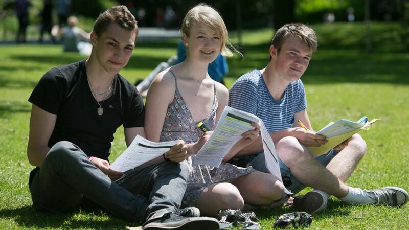 Institute of Education Leaving Cert students Matvey Binetskiy (left), Ruth Farnam and Ruairí Carroll enjoying the sunshine in St Stephen’s Green, Dublin, yesterday following exams. Photograph: Gareth Chaney/Collins