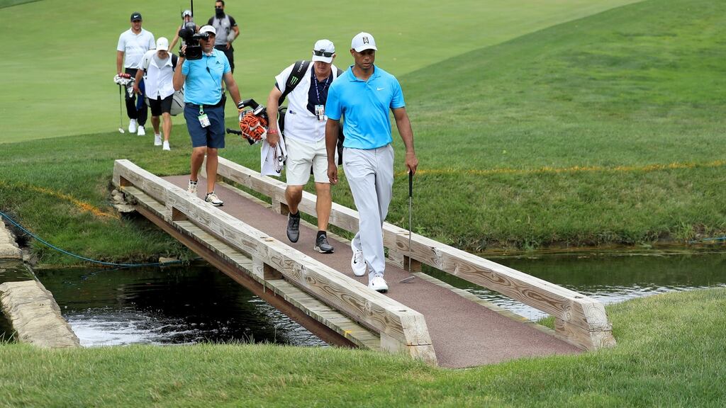 Tiger Woods of the United States walks with his caddie Joe LaCava during the first round of The Memorial Tournament. Photograph: Getty Images