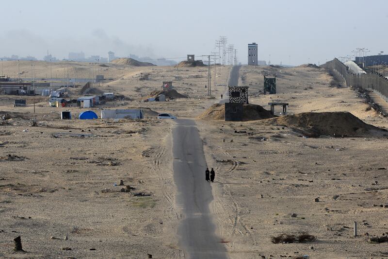 Two women walk on a road in the middle of a deserted camp for displaced Palestinians on the border with Egypt in Rafah on May 22nd. Photograph: Eyad AL-Baba/AFP via Getty