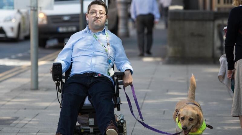 Padraic Moran with his assistant dog Gail: “The State doesn’t factor in the extra overheads people with disabilities encounter every day.” Photograph: Tom Honan