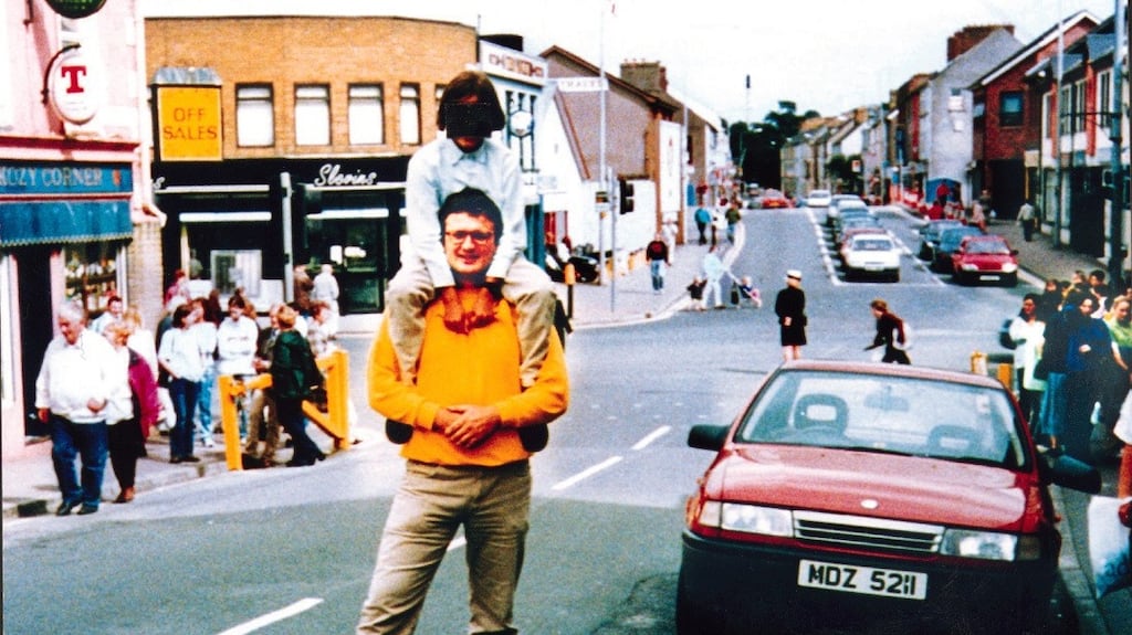 Spanish tourist Gonzalo Cavedo standing with a child on his shoulders beside the car carrying the bomb that exploded in Omagh on August 15th 1998. Mr Cavedo and the child survived but the photographer was killed. Photograph: RUC/PA