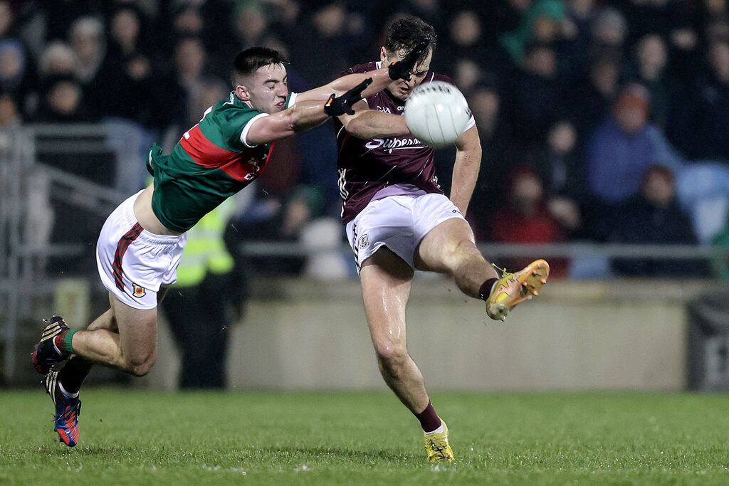Galway's Rob Finnerty scores a point despite the attempted block of Mayo's Enda Hession. Photograph: Laszlo Geczo/Inpho