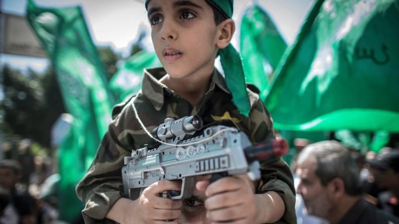 Palestinian boys play among the rubbles of a destroyed AL-Nada towers, hours before a 72-hours ceasefire between Israel and Hamas will come to an end in Beit Lahiya town in the northern Gaza. Photograph: Mohammed Saber/EPA