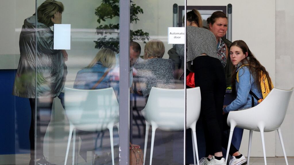People sit in a support centre at Manchester City’s Etihad Stadium. Photograph: Jon Super/Reuters