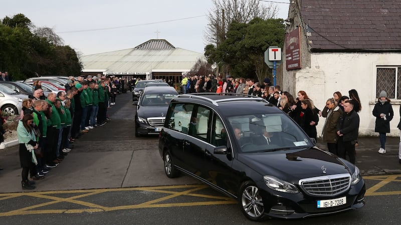 A hearse carrying the coffins of siblings, Conor, nine, Darragh, seven and Carla, three, McGinley, leaves the Church of the Holy Family in Rathcoole, Dublin. Photograph: Niall Carson/PA Wire