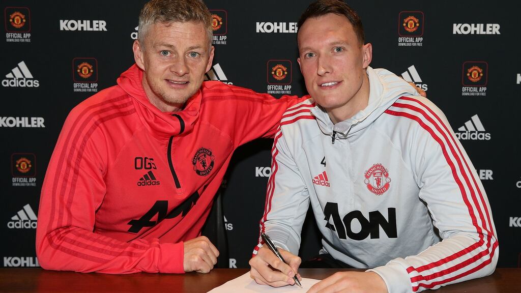 Phil Jones of Manchester United poses with caretaker manager Ole Gunnar Solskjaer after signing a contract extension. Photo: Matthew Peters/Man Utd via Getty Images