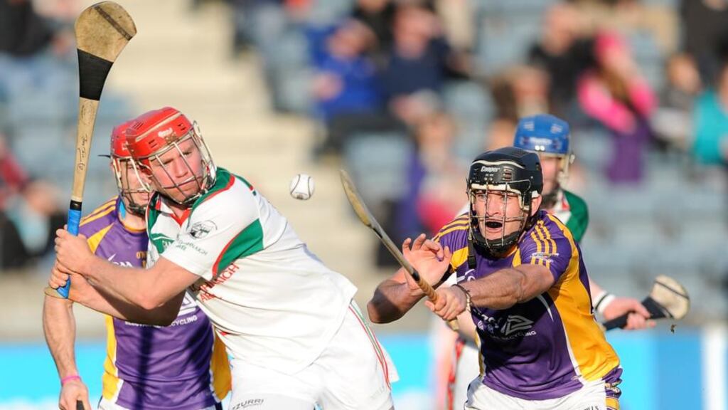 Rathdowney Errill’s Joe Fitzpatrick prepares to clear as Jude Sweeney of Kilmacud Crokes closes in at Parnell Park. Photo: Photo: Tommy Grealy/Inpho