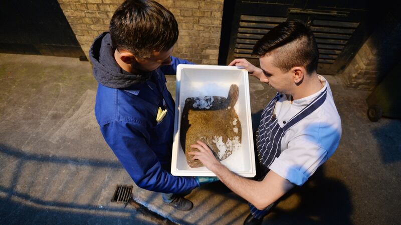 20/01/2017 -- Juniour sous Harry Quinn checking a delivery of fish Behind the scenes day in the life of Chapter One Michelin Star Restaurant. Photograph: Alan Betson / The Irish Times