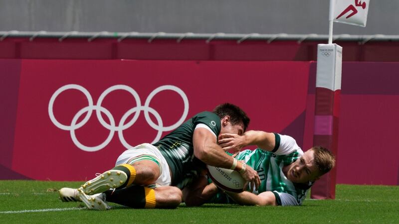 South Africa’s Impi Visser, left, scores a try past Ireland’s Terry Kennedy. Photo: Shuji Kajiyama/AP Photo