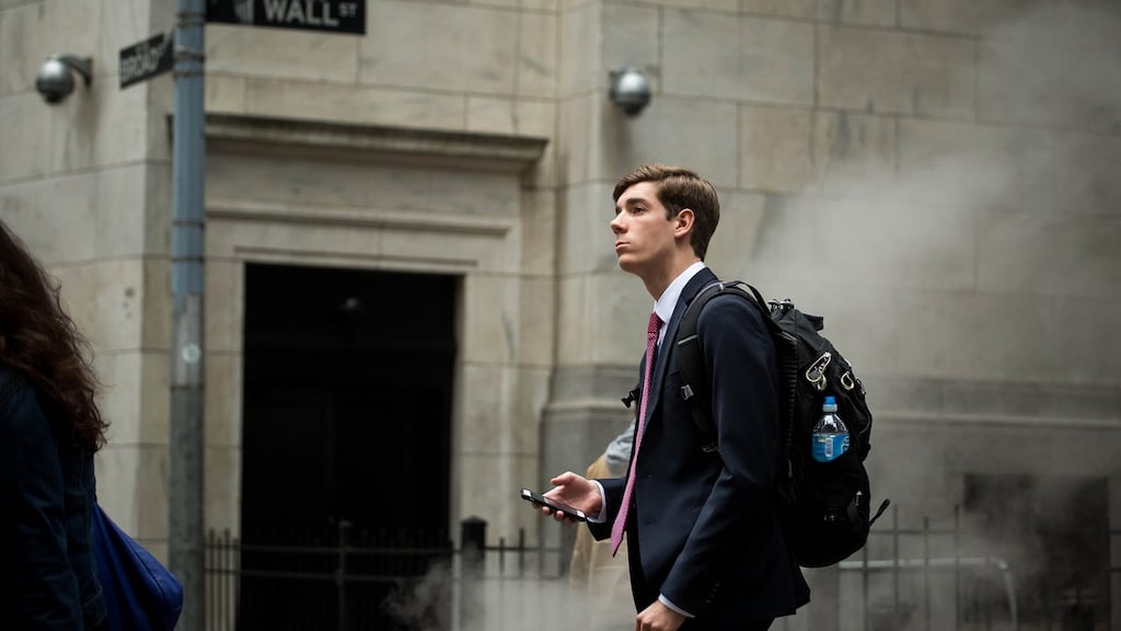 A pedestrian on Wall Street. For bankers, scuttled deals cost money. Photograph: Bloomberg