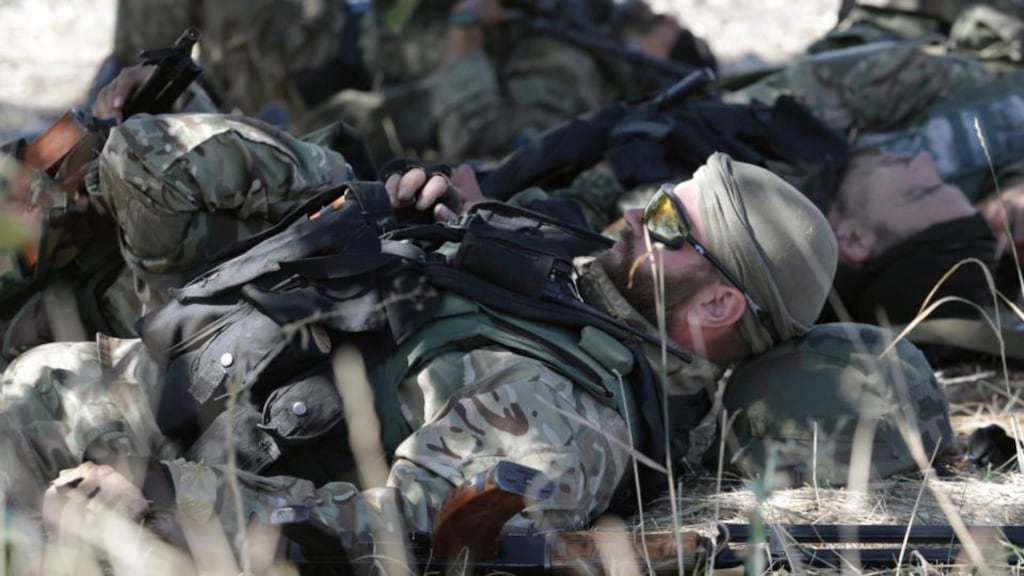 Soldiers of the Ukrainian self-defence battalion “Azov” rest at a checkpoint in the southern coastal town of Mariupol. Photograph: Vasily Fedosenko/Reuters