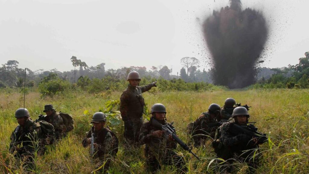 Peruvian special forces take up a defensive position during the detonation of a landing strip used by drug trafficking aircrafts near the Ene river in Pangoa district, Ayacucho. Photograph: Enrique Castro-Mendivil/Reuters