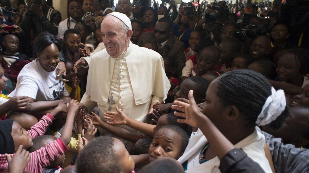 Pope Francis greets children during his visit in Nairobi, Kenya. The pontiff told a packed stadium in the city: ‘Let’s hold hands together, let’s stand up as a sign against bad tribalism.’