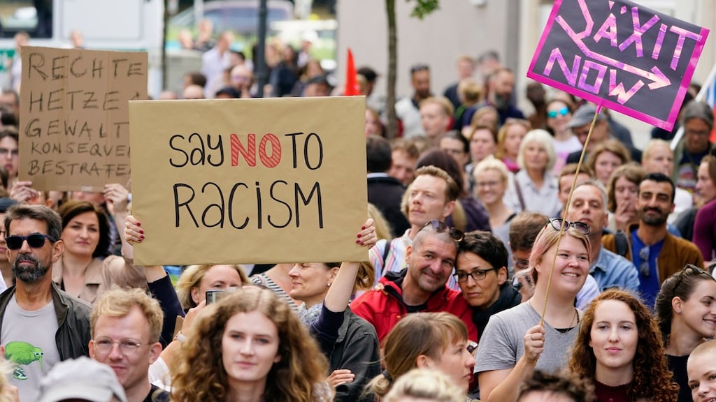 Demonstrators attend a vigil to protest against racism. Photograph: Alexander Becher/EPA