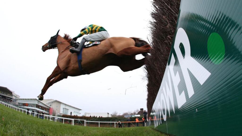Jockey Mark Walsh onboard Defy Logic clears the last fence on his way to winning the Racing Post Novice Steeplechase on day one of the Leopardstown Christmas Festival. Photograph: Cathal Noonan/Inpho