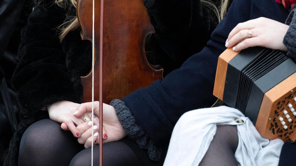 Trad musician friends of Ashling Murphy console each other at her funeral. Photograph: Colin Keegan/Collins