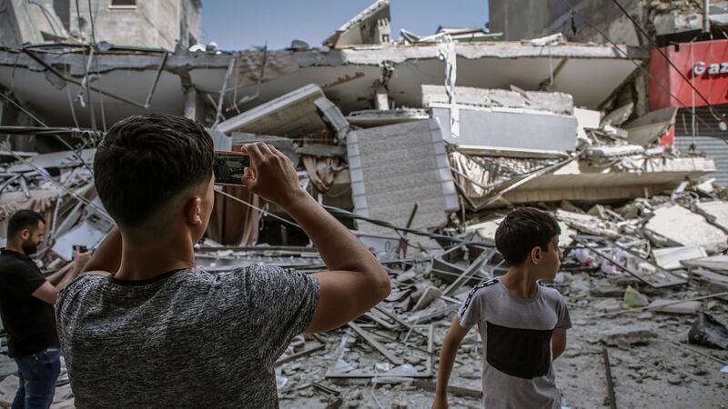 Palestinians inspect the remains of a house in Gaza on Thursday after it was destroyed by an Israeli air strike. Phortograph: Haitham Imad/EPA